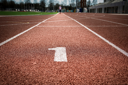 All-weather running track with highlighted number one, first place and way to goal conceptの写真素材