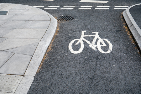 Bicycle road sign painted on the asphalt road. UK city streetの写真素材