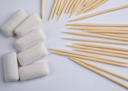 Toothpicks and chewing gum on white background. Dental hygiene and healthの写真素材