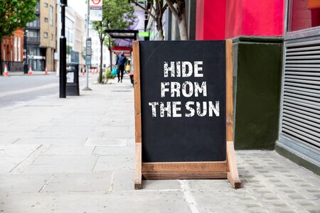 Hide from the sun. Foldable advertising poster on the streetの写真素材