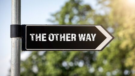 The other way concept for lost, confusion or decisions. Crossroad signpostの写真素材