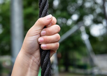 Hands holding rope. Playground, sports and a healthy lifestyle concept