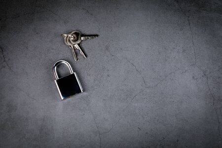 Padlock on gray concrete background. Privacy and Internet security concept. Space for text and pictureの写真素材