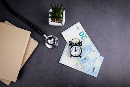 Euro money and stethoscope on concrete table. Medicine, health care and insurance conceptの写真素材