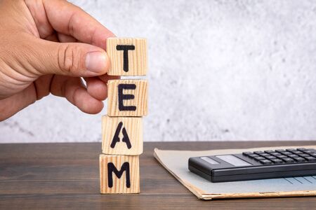 Team. Business, investment and marketing concept. Wooden letters on the office desk
