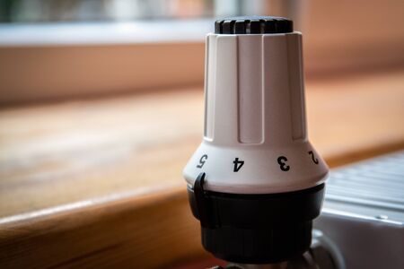 Closeup of a white radiator with thermostat.の写真素材