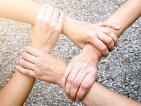 Close up top view of people putting their hands together. Friends with stack of hands, unity and...