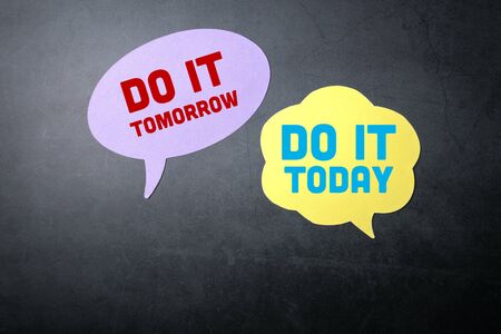 Do it today or tomorrow. Speech bubbles on a dark backgroundの写真素材