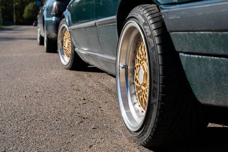 Green car with maxxis tyre. Cars parked on the side of the roadのeditorial素材