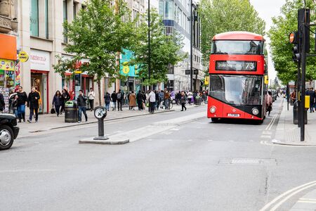 People on Oxford street, - the biggest shopping street in UK. Red bus number 73のeditorial素材