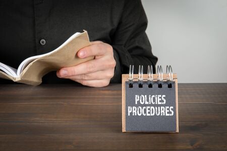 Policies and Procedures concept. Man reading a bookの写真素材