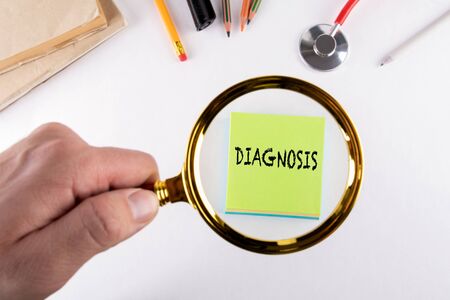 Diagnosis. Health care, analysis, research and rehabilitation concept. Man's hand, holding magnifying glassの写真素材
