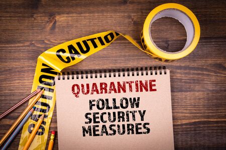 Quarantine. Follow security measures. Yellow plastic caution tapeの写真素材