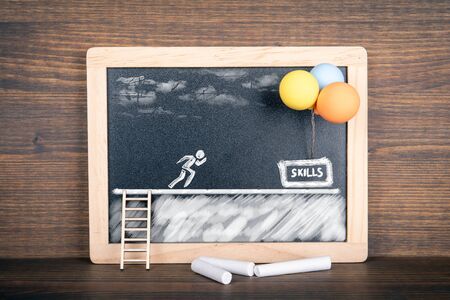 Skills concept. Instalation with stairs, white human figure and balloons on blackboard