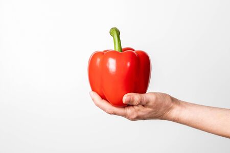 Woman holding red, sweet pepper or paprika. Health and healthy lifesyleの写真素材