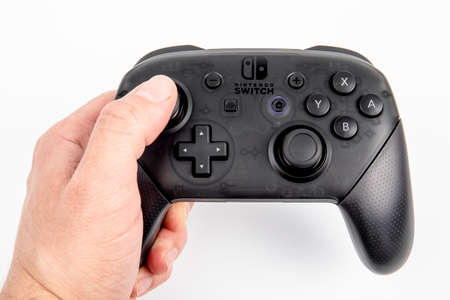 Nintendo Pro Controller for Nintendo Switch in hand of man, black console for gamers on white