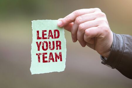 Lead Your Team. Text on the sheet in handの写真素材