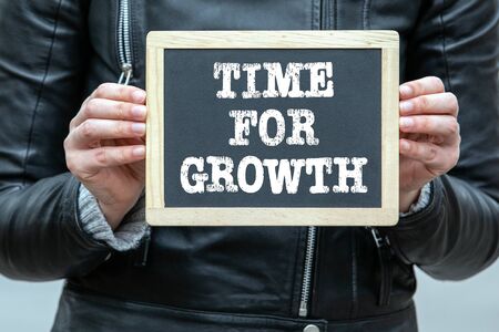 TIME FOR GROWTH. Text on chalk board