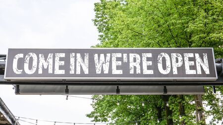 Come in Were Open. Advertising banner in urban environment. Business, information and marketing