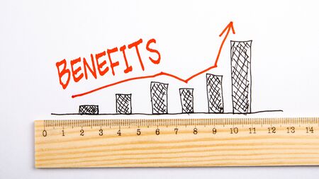 BENEFITS concept. Chart with arrow and wooden rulerの写真素材