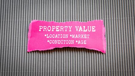 PROPERTY VALUE. Location, Market, Condition and Age concept. Text on torn, colored paperの写真素材