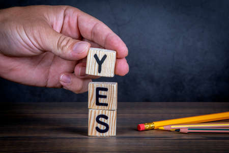 YES. Approval, support and consent concept. Wooden alphabet letters and pencilsの写真素材