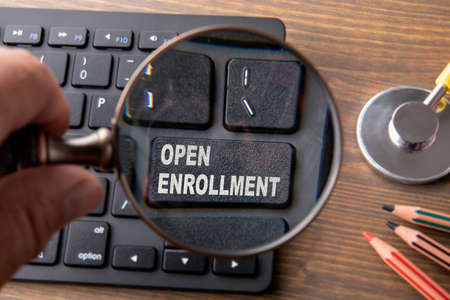 Open Enrollment. Insurance, healthcare, benefits and security concept. Computer keyboard and...