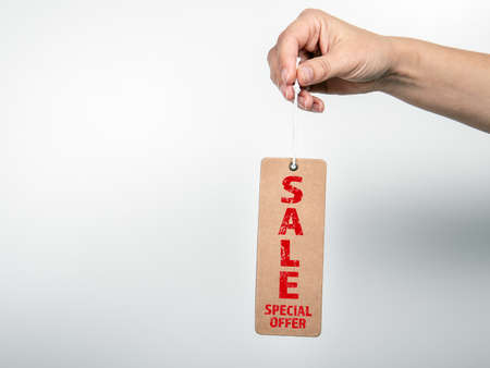 SALE SPECIAL OFFER. Price tag with a rope in a womans handの写真素材