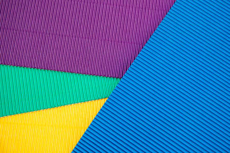 Corrugated application paper background. Blue, yellow, green and purple color. Place for textの写真素材