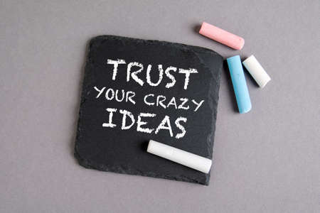 TRUST YOUR CRAZY IDEAS. Text on a stone surfaceの写真素材
