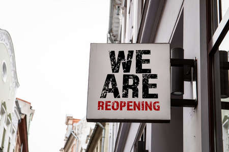 WE ARE REOPENING. Advertising sign on the wall of the houseの写真素材
