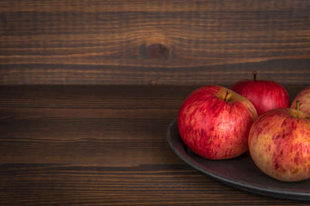 Local apples. agriculture, production and healthy eating concept. Dark wooden background with texture. Copy spaceの写真素材