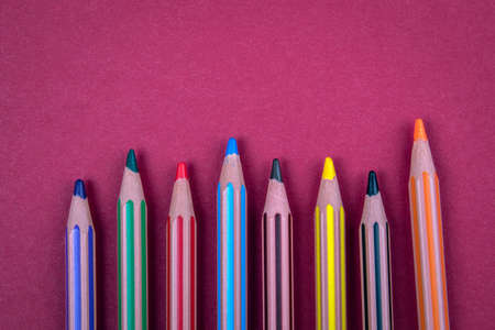 Colored pencils on a red background. Free text space for advertising and marketingの写真素材