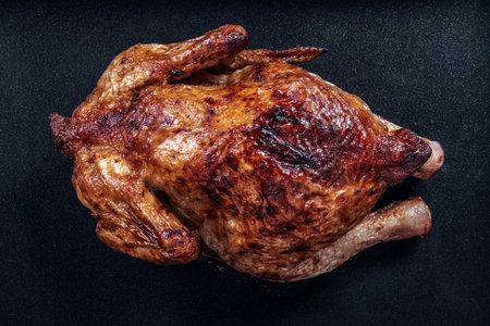 Grilled chicken on black surface. Food and nutrition concept. Recipe for dinnerの写真素材