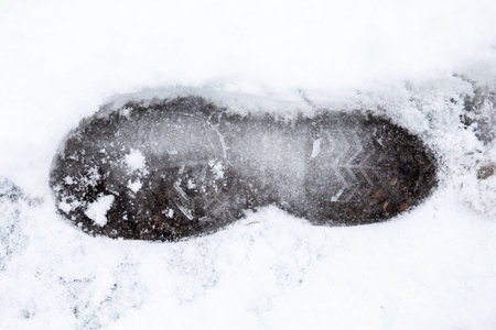 Footprint in the snow after sowfall. Mark of someoneの写真素材