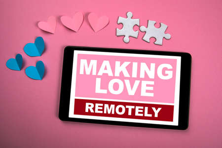 Making Love Remotely. Relationships, data security, trust and technology concept. Tablet, paper...