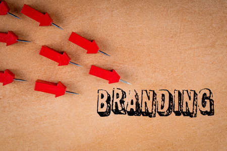 Branding. Business concept. Red arrows on an orange backgroundの写真素材