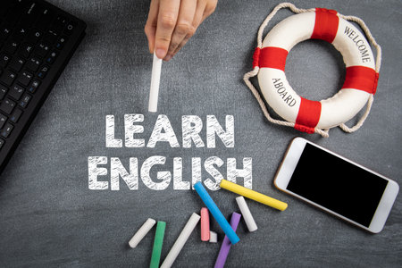 Learn English. Education, distance learning and career concept. Computer keyboard and mobile phoneの写真素材