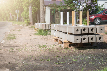 Concrete fence posts on wooden pallets. Improvement and repair worksの写真素材