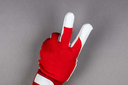 Man hand with leather work glove showing two fingers
