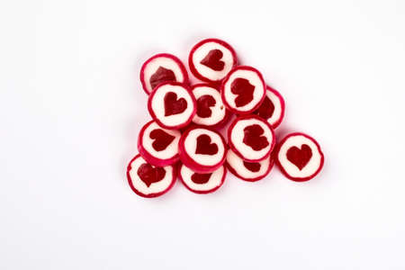 Valentines day and relationships concept. Caramel candies in the form of hearts on a white...