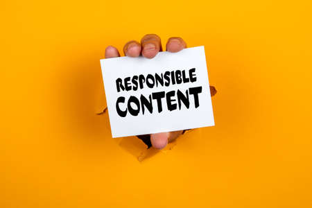 Responsible Content. Note paper in a womans hand. Yellow background