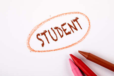 STUDENT. Colored crayons on a white sheet of paperの写真素材