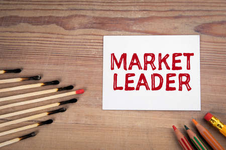 Market Leader. Burnt matches and pencils on a wooden tableの写真素材