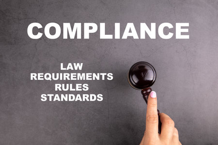 COMPLIANCE. Law, Requirements, Rules and Standards concept. Court hammer in womans handの写真素材