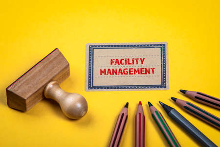FACILITY MANAGEMENT. Yellow notes and documents folder. Office supplieの写真素材