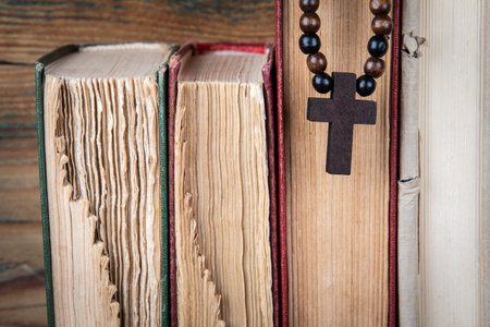 Old books and wooden cross. Religion, prejudice, prohibition and faith conceptの写真素材