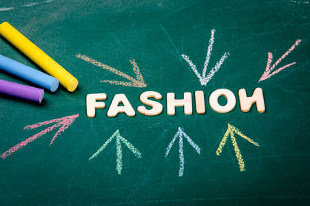 Fashion. Colored pieces of chalk on a green chalk board