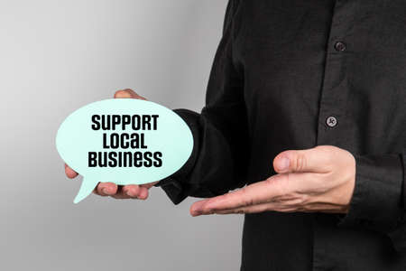 Support Local Business. Business man with speech bubble in handの写真素材