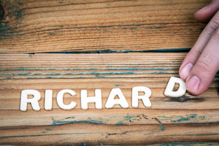 RICHARD. Name of men and boys. Birthday concept. White letters of the alphabet on a wooden backgroundの写真素材